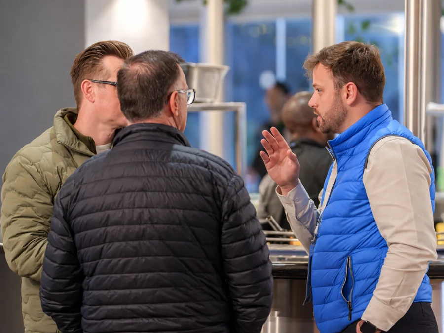 Justin in conversation with two event attendees